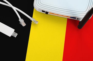 Belgium flag depicted on table with internet rj45 cable, wireless usb wifi adapter and router....