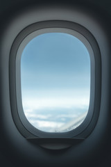 Airplane window. Glass in focus sky blurry