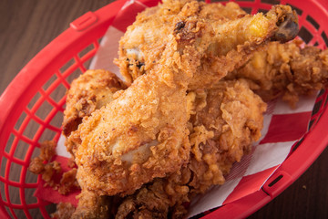 fried drum stick chicken in plastic basket
