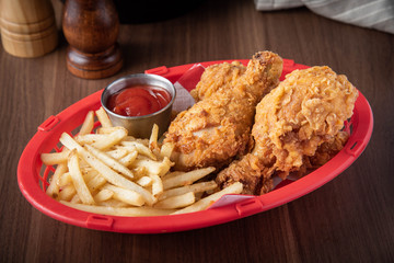 fried chicken with french fries in plastic basket