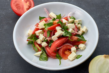 Vegetable salad with cheese, on a white plate