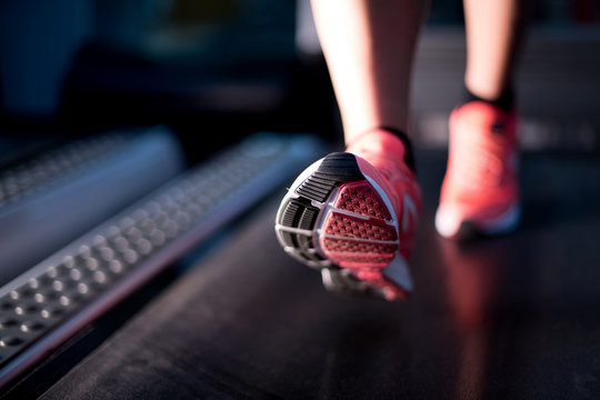 oot of a girl who is warming up on a treadmill. Close up