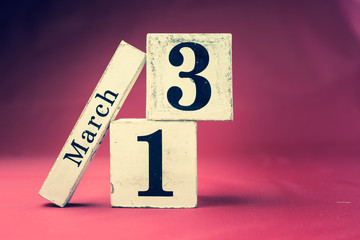 March 13th, Thirteenth of March, Day 13 of month March - vintage wooden calendar blocks on maroon background with empty space for text
