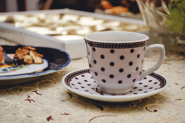 Coffee with candy and nuts on the table