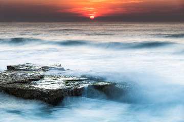 Fototapeta na wymiar Rocky Smoke Haze Sunrise Seascape