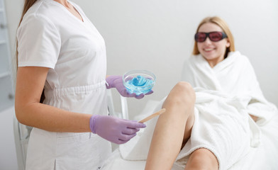 Naklejka premium laser epilation and sugaring in beauty salon