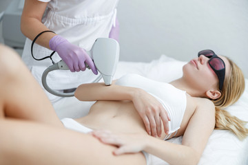 young girl in beauty salon, laser epilation and beauty