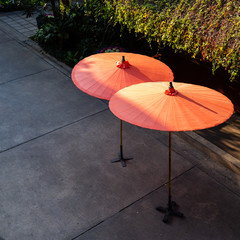 Red  bamboo wood umbrella with sunlight shadows