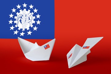 Myanmar flag depicted on paper origami airplane and boat. Handmade arts concept