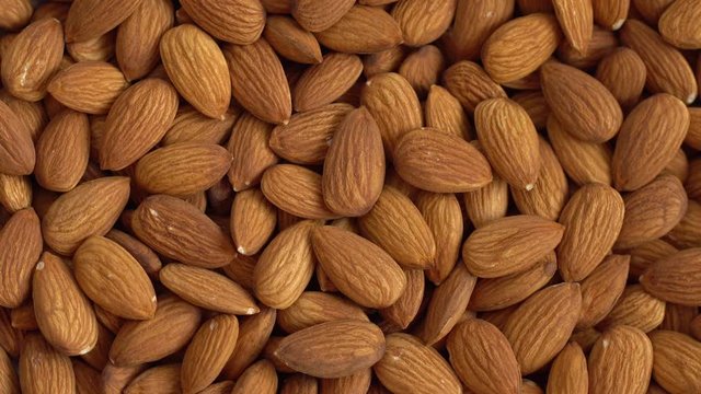 Walnut close up. product rich in minerals and vitamins. Almond turns in a shot. Almond kernels rotating. walnut close up lies under beams of the sun. Macro
