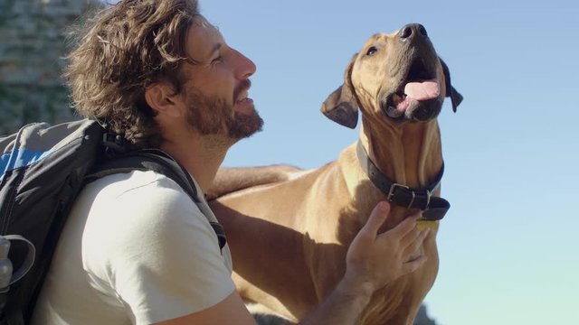 Close bond between man and dog, happy outdoors active lifestyle with pet