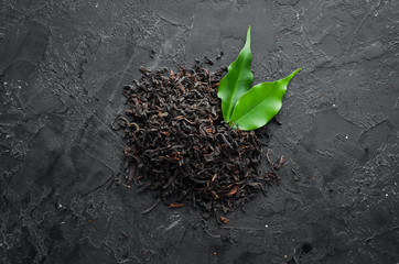 Dry black tea. On a rustic background. Top view. free space for your text.