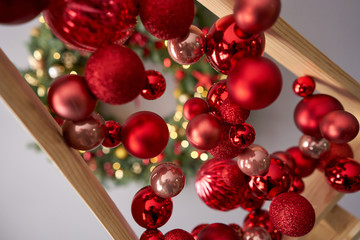 Close up red christmas balls. Alternative wooden christmas tree. A handmade Christmas tree.