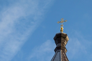 Fototapeta na wymiar Orthodox church under restoration against the blue sky from the bottom up.