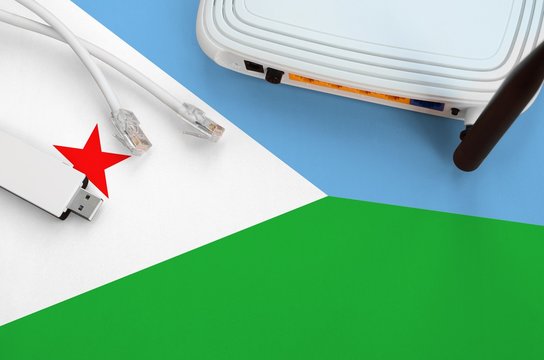 Djibouti flag depicted on table with internet rj45 cable, wireless usb wifi adapter and router. Internet connection concept