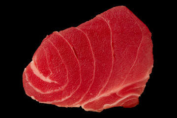 Tuna fillet on black background. Seafood cooking. Useful and tasty food.