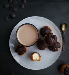 Profiteroles with vanilla cream and chocolate