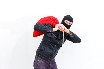 Thief robbed bank and is carrying full bag of money. Isolated on white background.