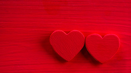 Two red heart on the red wooden table. Valentine's Days background.