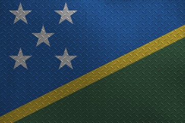 Solomon Islands flag depicted in paint colors on old brushed metal plate or wall closeup. Textured...