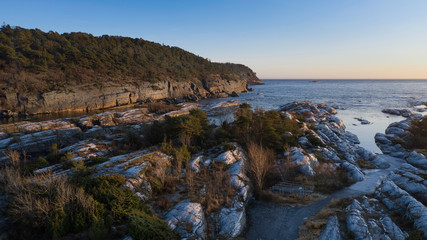 Fototapeta na wymiar Frost stones by the sea coast in a winter day