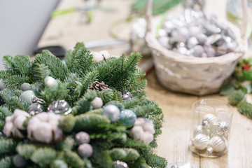Christmas decor with their own hands. Master class on making decorative ornaments. Flower shop. Woman created a xmas arrangement.