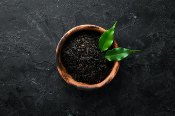 Dry black tea. On a rustic background. Top view. free space for your text.