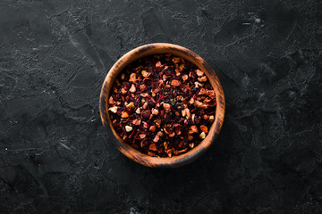 Dry fruit and berry tea. On a rustic background. Top view. free space for your text.