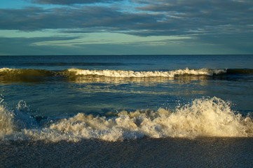 Large breaking waves on bonita beach at the gulf of mexico in bonita springs florida at sunrise.