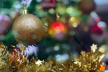 Christmas balls and colored garlands on a Christmas tree branch