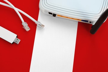 Peru flag depicted on table with internet rj45 cable, wireless usb wifi adapter and router....