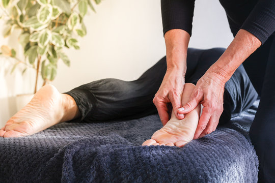 Traditional shiatsu massage done by mature therapist.
