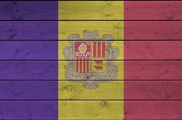 Andorra flag depicted in bright paint colors on old wooden wall. Textured banner on rough background