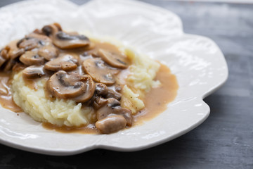 mashed potato with mushrooms and sauce on white dish
