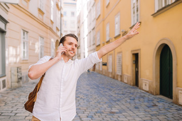 Fototapeta premium Young man background the old european city take selfie