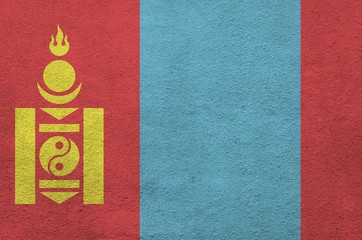 Mongolia flag depicted in bright paint colors on old relief plastering wall. Textured banner on...
