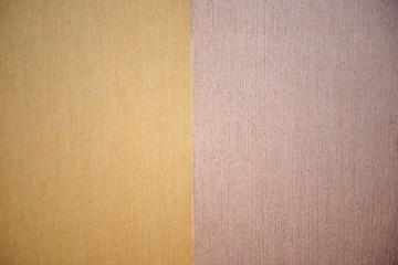 Closeup wall texture with wallpaper in brown tones.