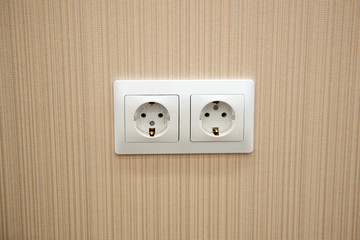 Double white electrical outlet on the wall.