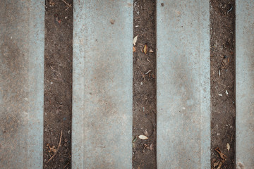 Nature and civilization interaction background texture. Stone, asphalt, concrete vertical stripes, dry empty ground. Copy space text. Gray color industrial backdrop. Old surface parallel lines