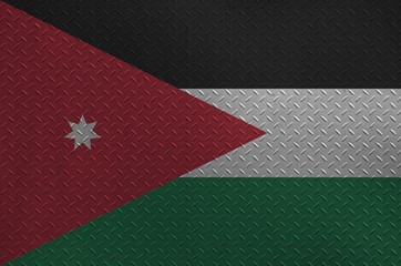 Jordan flag depicted in paint colors on old brushed metal plate or wall closeup. Textured banner on...