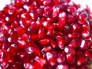 bright pomegranate seeds close up in a plate