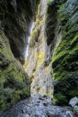 Fototapeta na wymiar volcanic cave of Gljufrafoss with a little creek in Iceland