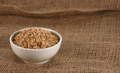 Buckwheat in bowl on jute background