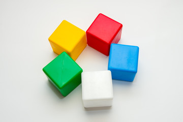 Children's colorful cubes on a white background, children's toys, educational games.