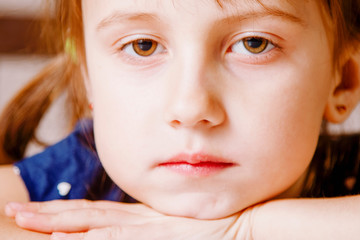 Close up portrait of a sad and lonely little girl alone with her problems.