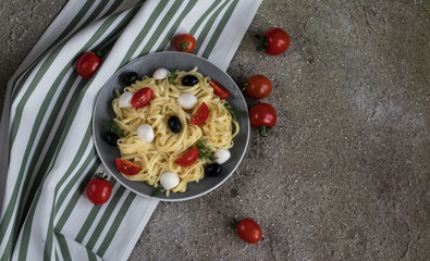 tasty pasta with red tomatoes, olives and mozarella