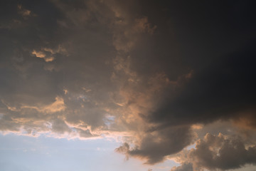 Naklejka na ściany i meble Dramatic sky with dark clouds against blue sky. weather concept
