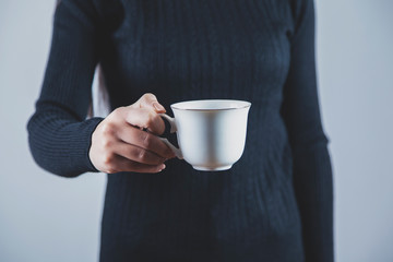 woman hand holding cup of coffee or tea