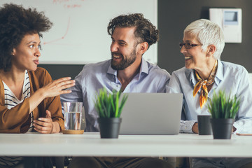 Group of coworkers sitting and working together on new startup project