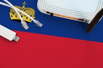 Liechtenstein flag depicted on table with internet rj45 cable, wireless usb wifi adapter and...